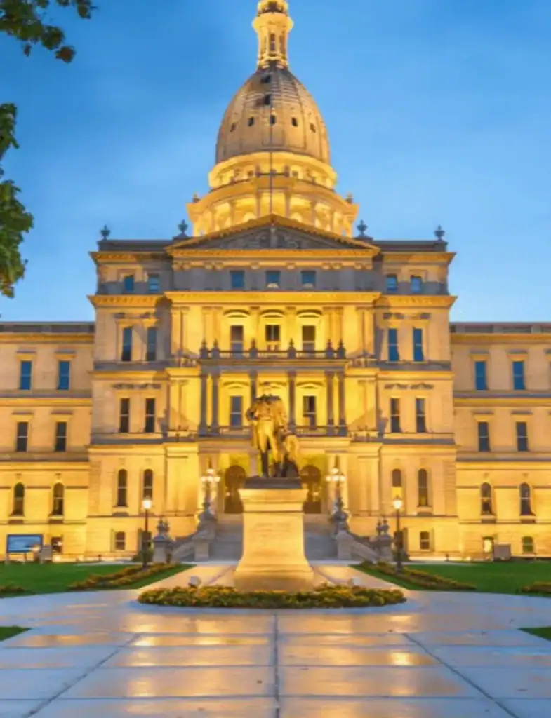 Michigan State Capitol building illuminated at twilight—highlighting Lansing as a key service location for Grey Cap.